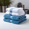 Coordinated comfort Stacked towels in blue, white, and gray showcase elegance