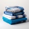 Coordinated comfort Stacked towels in blue, white, and gray showcase elegance