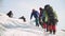 Coordinated a group of climbers climb the steep snow slope of the mountain, they were tired but continue to go