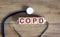 COPD medical concept. Wooden cubes with the inscription `COPD - chronic obstructive pulmonary disease`, stethoscope. Beautiful