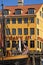 Copenhagen, antique house with bright facade and old ship moored in Nyhavn
