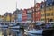 Copenhagen, Denmark - July 2015: Crowded quayside terrace cafes in Nyhavn New Harbour during summer