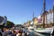 Copenhagen, Denmark- May 30, 2023: Nyhavn pier, colorful view from canal tour boat with many people