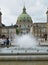 COPENHAGEN, DENMARK - MAY 31, 2017: fountain in Amalie Garden with the dome of Frederik`s Church and statue of King Frederick V