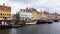 COPENHAGEN, DENMARK - MAY 31, 2017: people in open cafes of the famous Nyhavn promenade. Nyhavn a 17th century harbour