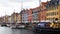 COPENHAGEN, DENMARK - MAY 31, 2017: people in open cafes of the famous Nyhavn promenade. Nyhavn a 17th century harbour