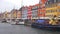 Copenhagen, Denmark - May 31, 2017: tourists in open cafes of famous Nyhavn promenade with typical colorful houses and water canal