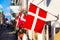 Copenhagen iconic view. Denmark flags near Nyhavn canal on medieval houses in the center of Copenhagen, Denmark during summer