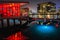 Copenhagen `s canal at night with red and blue underwater neon lights and modern buildings by the water reflecting on a calm sea