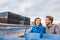 Copenhagen tourists couple on city boat cruise tour enjoying view of the black diamond Royal library, famous architecture building