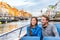 Copenhagen tourists people on Denmark travel holiday cruise boat tour in old port. Young multiracial couple travelers relaxing