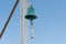 Copper bell on boat yacht on blue sky background