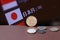 The copper coin of Japanese Yen money and the coins on brown floor with digital board of currency exchange background