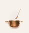 Copper cooking pot with spoon on white