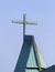 Copper cross on church with green patina
