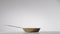 Copper fryingpan spinning on on a light gray studio background. Round empty stainless or aluminum pan with handle