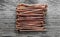 Copper nails on wooden board