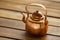 Copper old scratched vintage crockery kitchenware kettle on the table