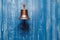 Copper old vintage bell, doorbell, rope on a wooden blue aged wall. Concept decor element in interior of deck, cabin of ship,