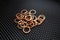 Copper washers on black metal mesh background