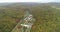 Copter view of landscape. Buildings surrounded by forest and mountains. Nature parks