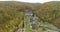 Copter view of landscape. Buildings surrounded by forest and mountains. Nature parks