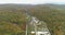 Copter view of landscape. Buildings surrounded by forest and mountains. Nature parks