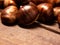 copy space,chestnuts photographed very closely, close to camera, close-up, on wooden table and morning sunlight