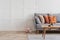 Copy space on empty white wall of fashionable living room interior with grey and orange design