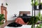 Copy space on empty white wall of rustic bedroom interior with king size bed with orange bedding and black duvet