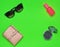 Copy space of female fashion accessories layout on a green background. Mirror, sunglasses, purse, perfume bottle. Top view