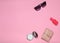 Copy space of female fashion accessories layout on a pink background. Mirror, sunglasses, purse, perfume bottle.