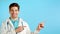 Copy space portrait of smiling man in professional medical white coat indicates with hands on his left up side. Doctor