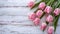 copy space, stockphoto, springtime pink tulips on white rustic wooden background for Mothers Day. Mother\\\'s day mockup.