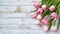 copy space, stockphoto, springtime pink tulips on white rustic wooden background for Mothers Day. Mother\\\'s day mockup.