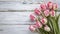 copy space, stockphoto, springtime pink tulips on white rustic wooden background for Mothers Day. Mother\\\'s day mockup.