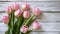 copy space, stockphoto, springtime pink tulips on white rustic wooden background for Mothers Day. Mother\\\'s day mockup.