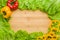 Copy space on a wooden or bamboo background, covered with vegetables and lettuce. You can write here your menu or any inscription