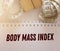 Copybook with words Body Mass Index and measuring tapes. Healthcare concept