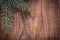 copyspace christmas background branches of fir tree on old wooden board horizontal version