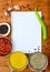 Copyspace food frame with notepad paper spices and cooking accesories