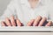 Copywriter freelancer work concept - hands are typing on keyboard. Hand holds wooden blocks on a white background