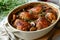 Coq au Vin: A rich, rustic stew featuring chicken simmered in red wine with mushrooms and onions.