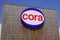Cora sign blue white and red text logo on hypermarket facade