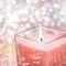 Coral aromatic candle on Christmas and New Years glitter background, Valentines Day luxury home decor and holiday season brand