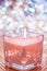 Coral aromatic candle on Christmas and New Years glitter background, Valentines Day luxury home decor and holiday season brand