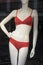 coral color bikini on mannequin in fashion store showroom for women