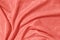coral colored draped fabric with silver lurex thread