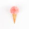 Coral fur ball in waffle cone on white background