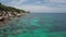 Coral Reef in Turquoise Lagoon Water beside Rocky Shoreline with Big Stones in Tropical Country. Aerial Top View